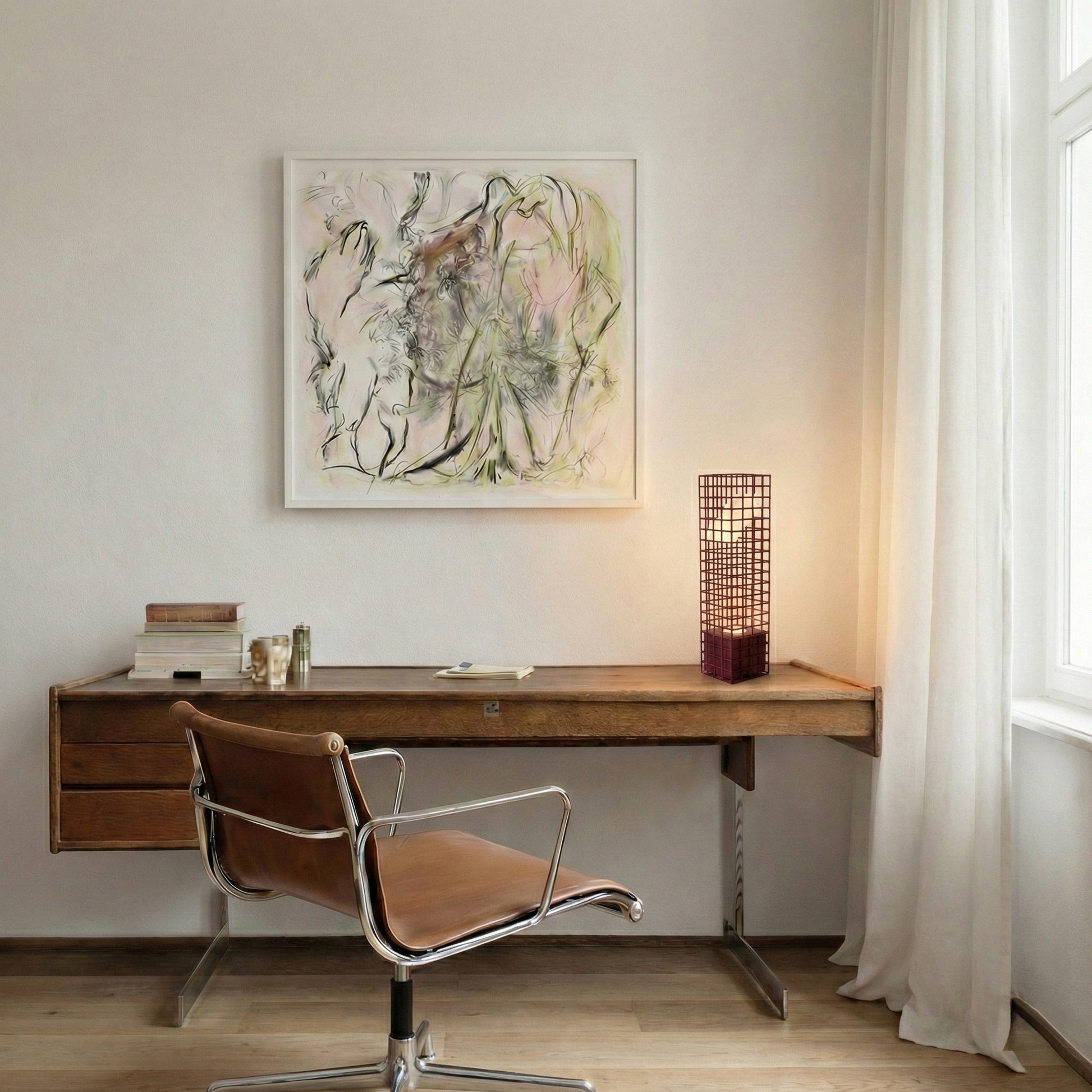 Modern home office with wooden desk, leather chair, and abstract art on the wall. A maroon mesh lamp is lighted up on the desk.