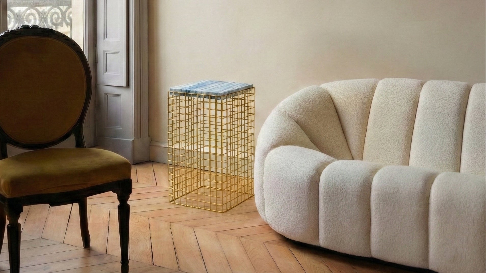 Living room with a vintage chair, modern sofa, and side table.