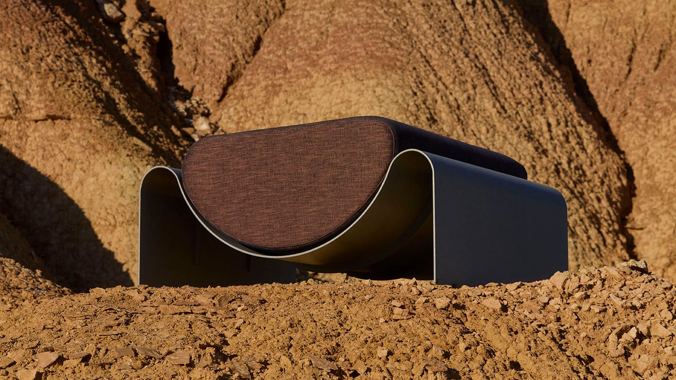Modern black and brown chair against a rocky desert background